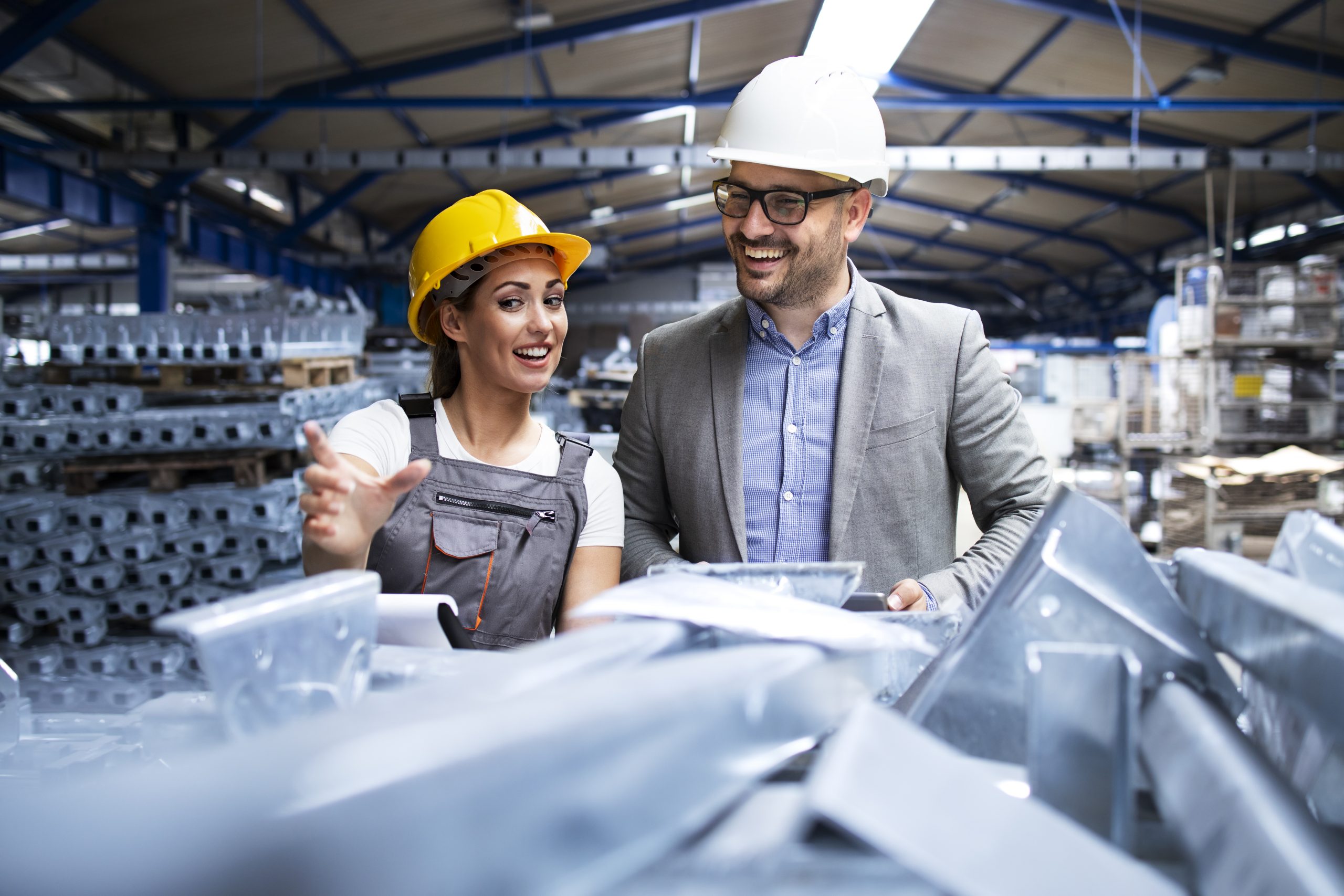 Quality control engineer inspecting manufactured components on the production line